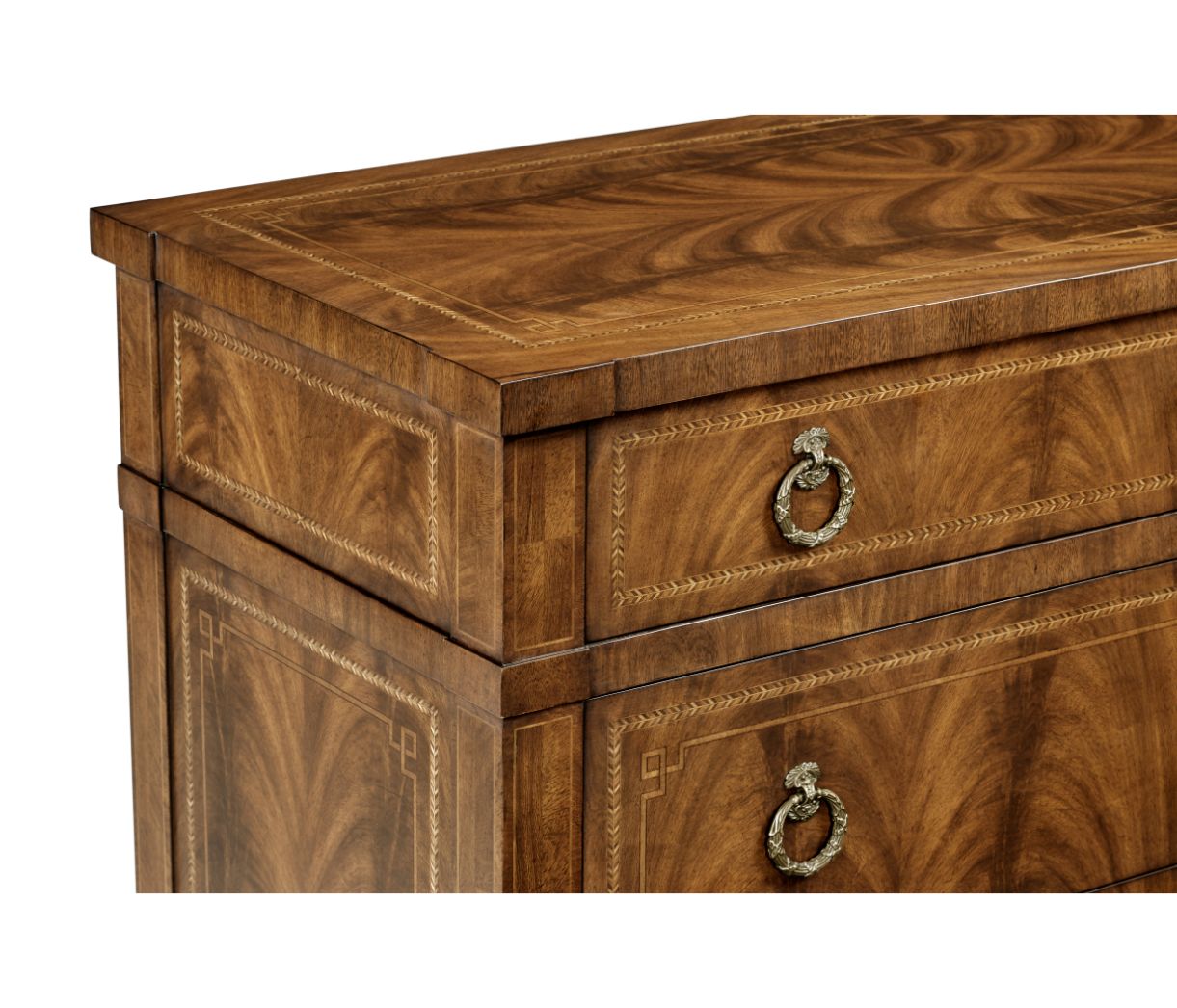 Close-up of walnut veneer dresser top edge featuring chevron inlay borders and scrollwork handles