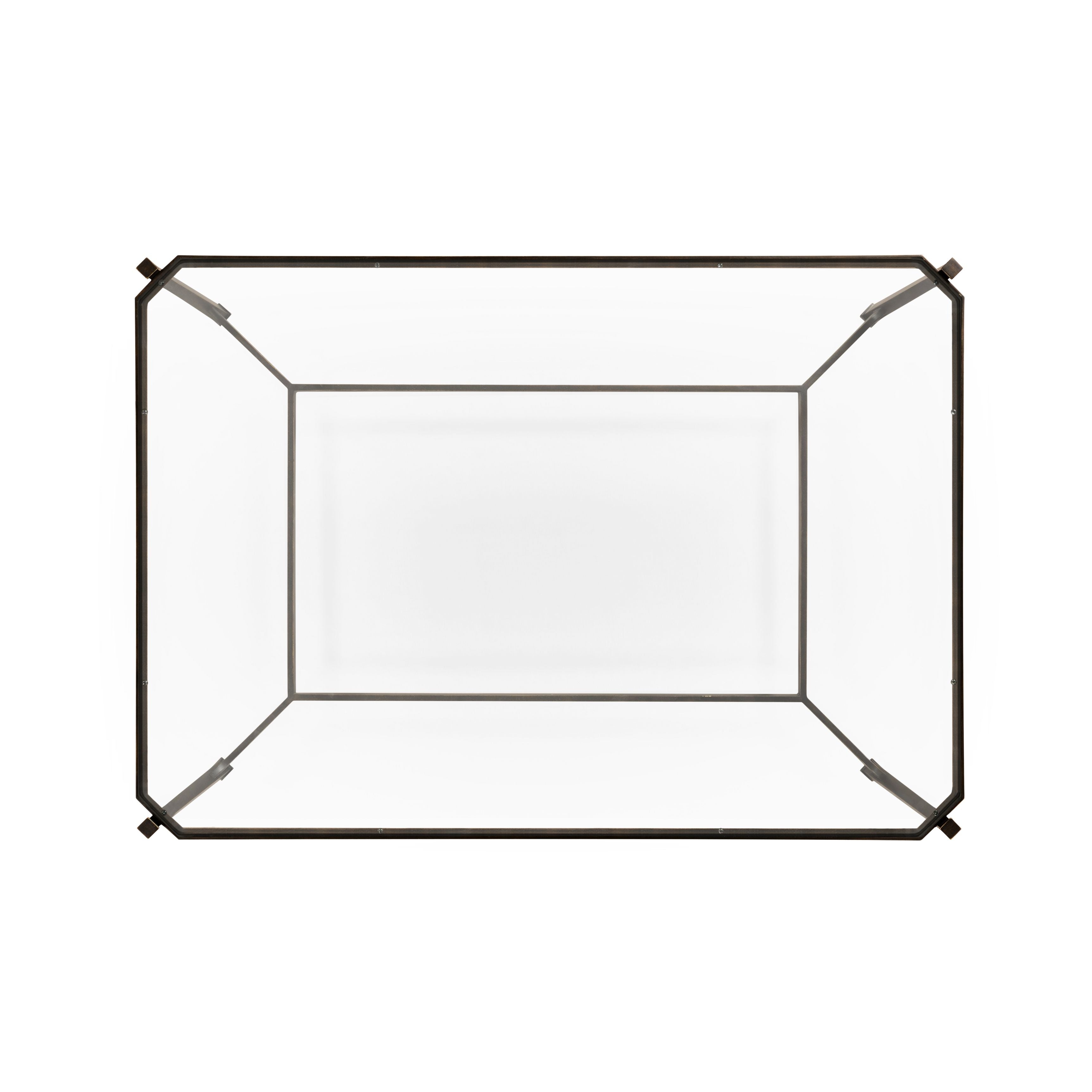 Top-down view of rectangular bronze wrought iron coffee table with inset glass top and beveled corner joints