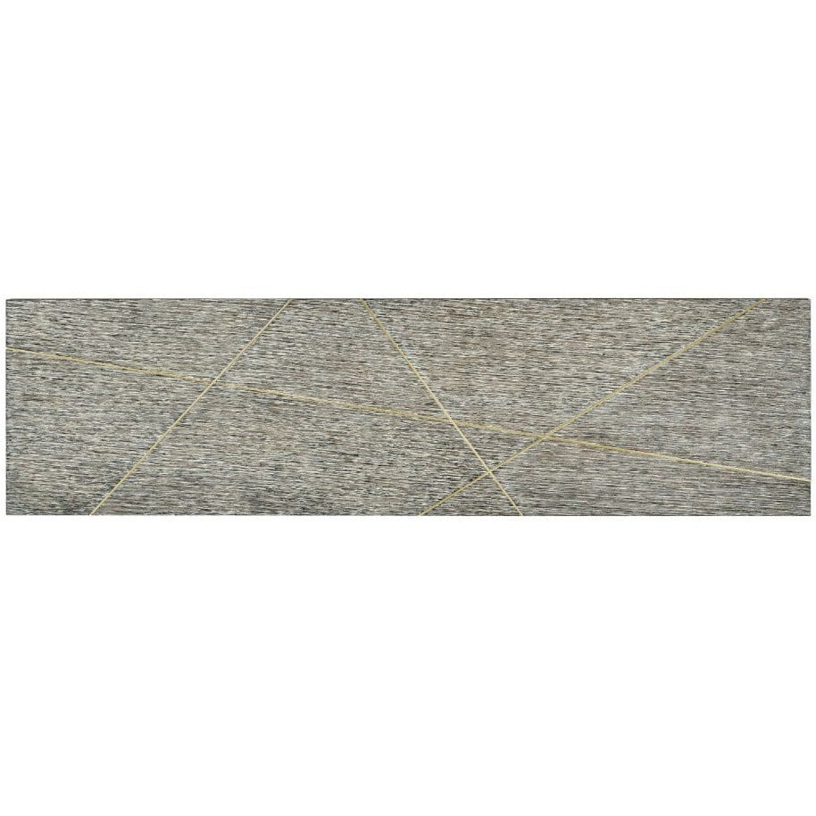 Top-down detail of geometric gold inlay pattern on weathered gray-brown oak surface