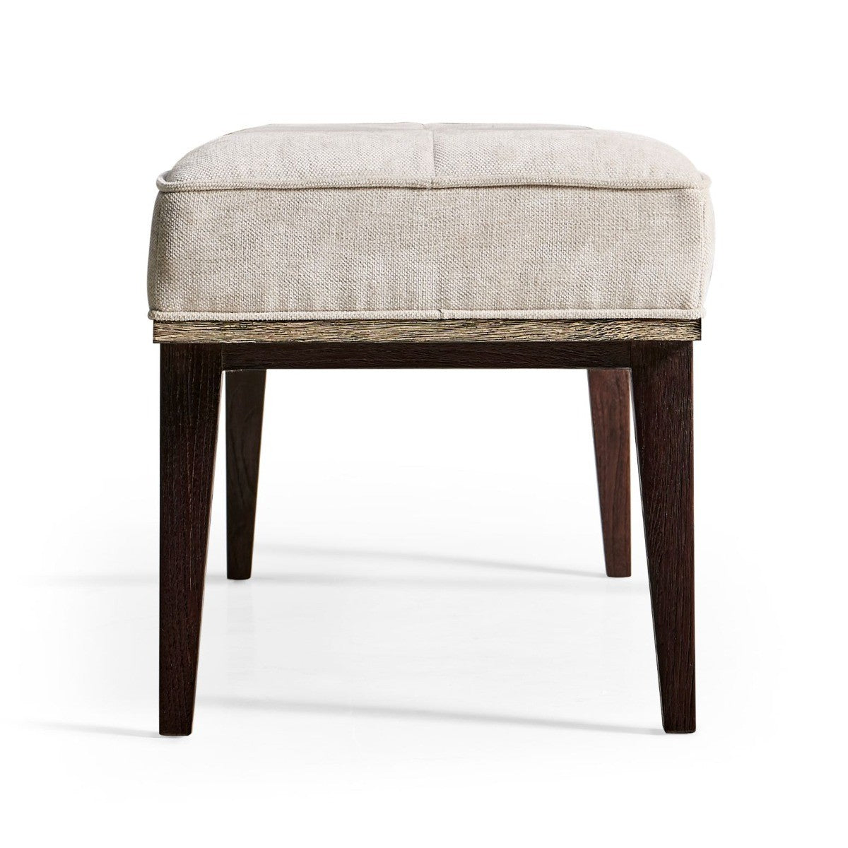 Close-up rear angle of Jonathan Charles compact square bench highlighting thick padded seat, four tufted sections, and exposed natural wood edge trim