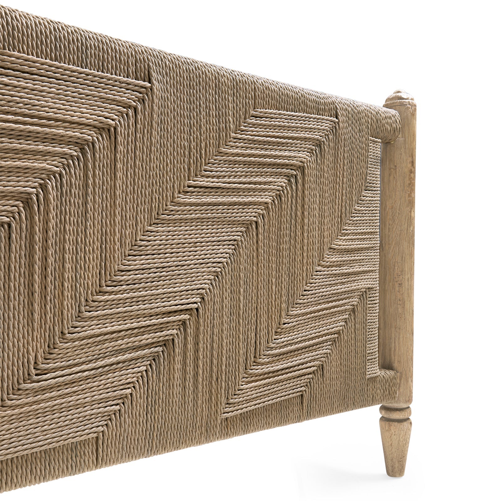 Footboard corner close-up showing light oak leg and geometric rush weave pattern on Jonathan Charles Sagehill bed