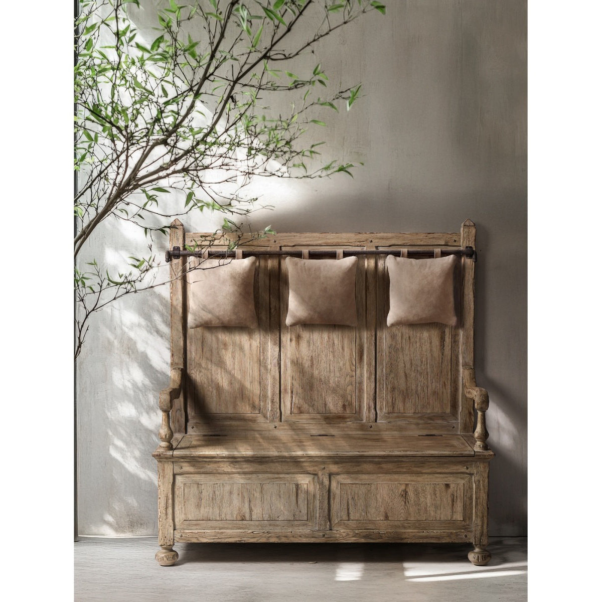 Sagehill hall bench styled in sunlit room with leaf shadows and hanging beige pillows