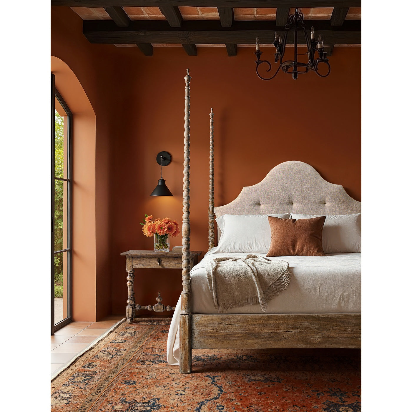 Warm rustic bedroom scene with Jonathan Charles Caldera four-poster bed, terracotta walls, and fringed throw blanket styling