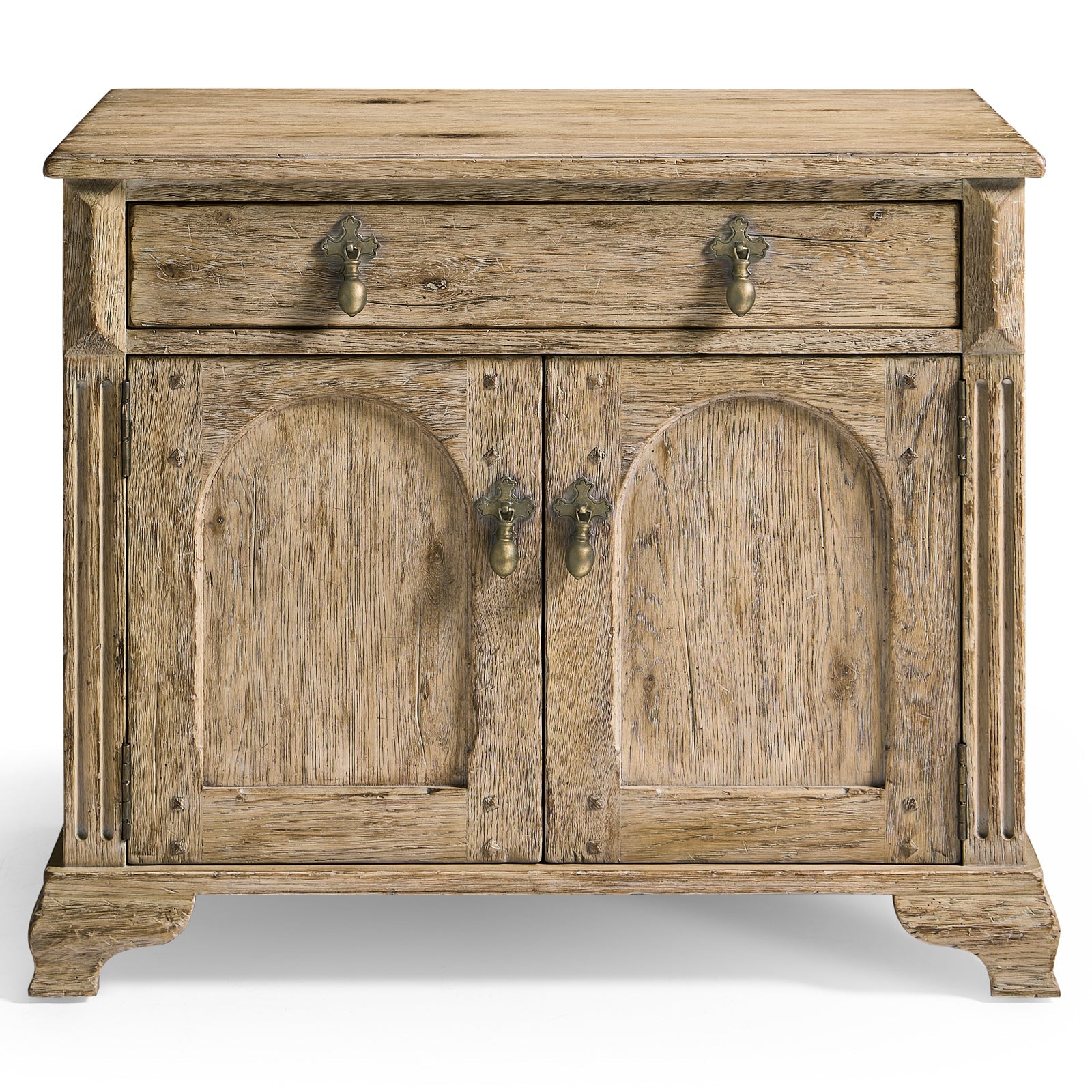 Jonathan Charles Sagehill rustic oak nightstand with arched panel doors, brass acorn pulls, and carved block feet