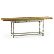 Side view of extending dining table with natural oak top, distressed country grey base, and carved leaf cutouts