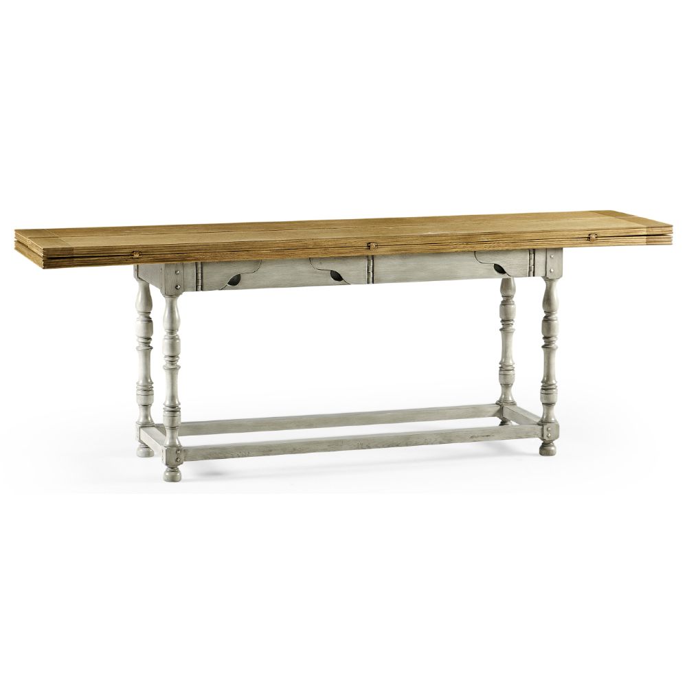 Side view of extending dining table with natural oak top, distressed country grey base, and carved leaf cutouts
