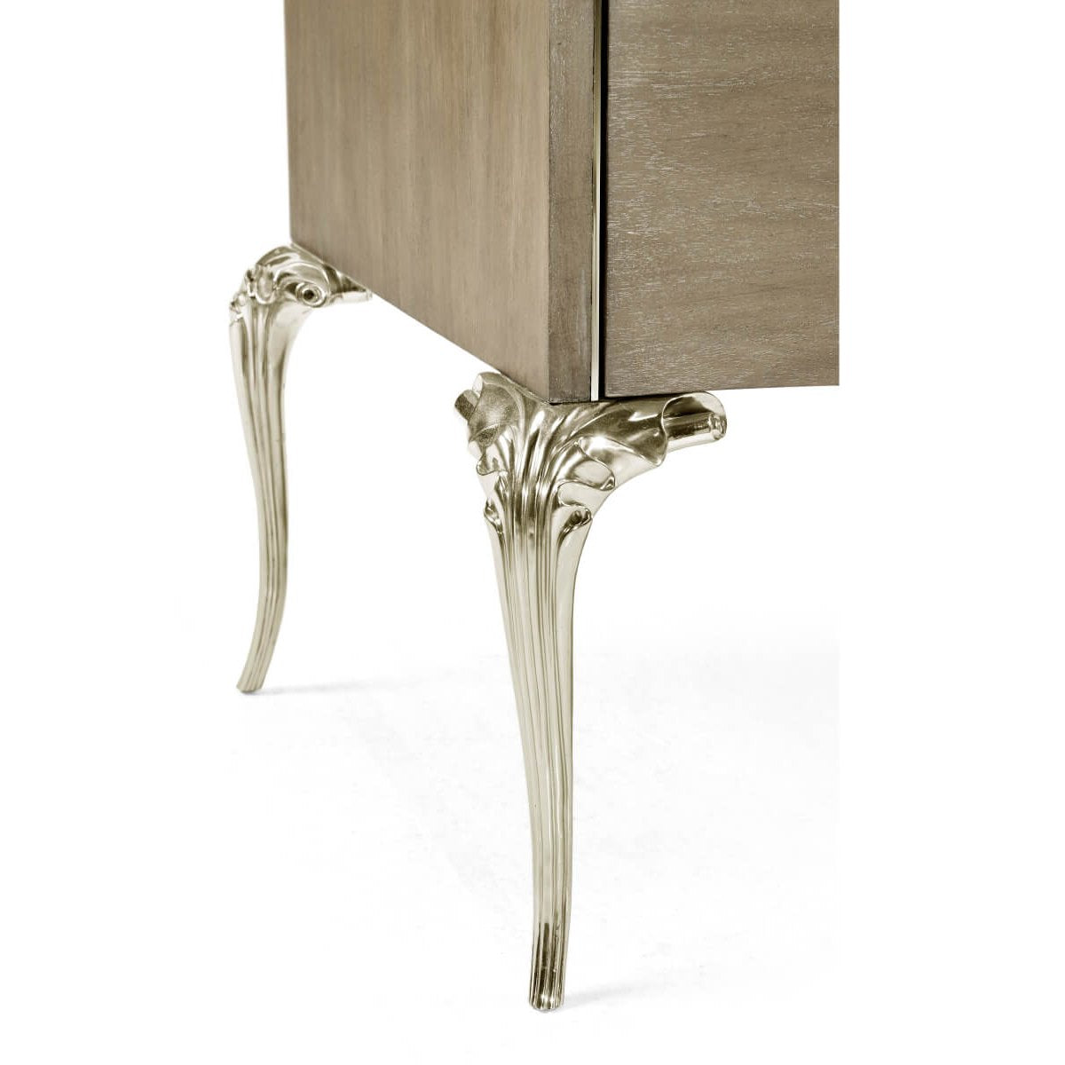 Close-up of Jonathan Charles Parisian dresser leg with ornate silver cabriole design and leaf fluting against walnut wood grain