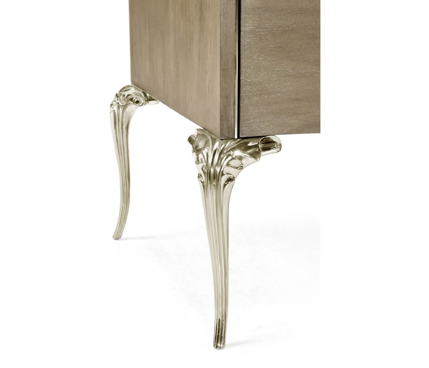 Close-up of Jonathan Charles Parisian dresser leg with ornate silver cabriole design and leaf fluting against walnut wood grain