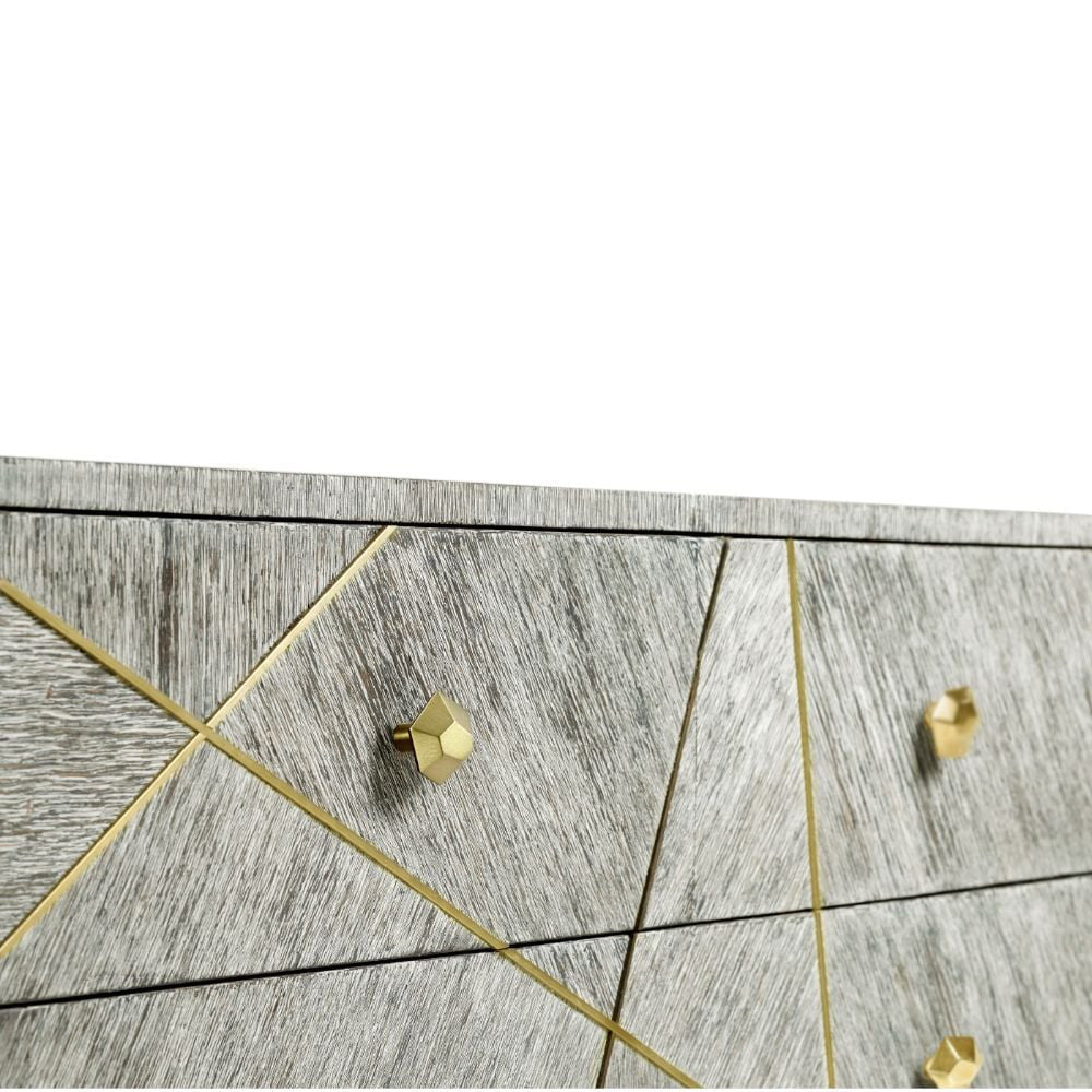 Corner detail of transitional dresser featuring faceted gold knobs and intersecting gold linear accents
