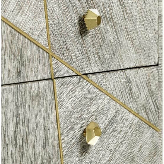 Close-up of textured light gray wood grain with diagonal gold metal inlay strips on dresser drawers