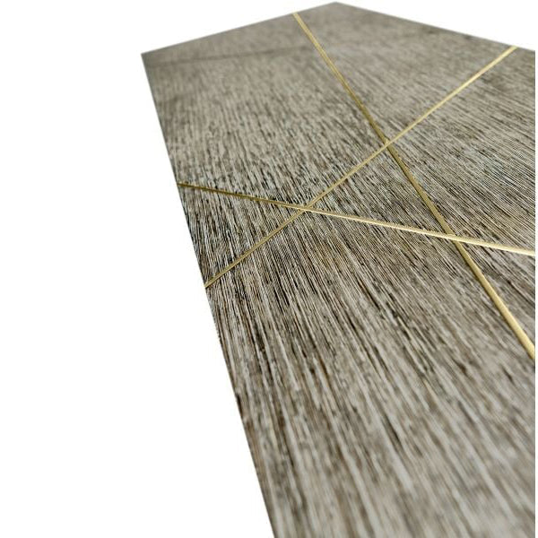 Close-up textured cerused oak tabletop with abstract gold metal line inlays