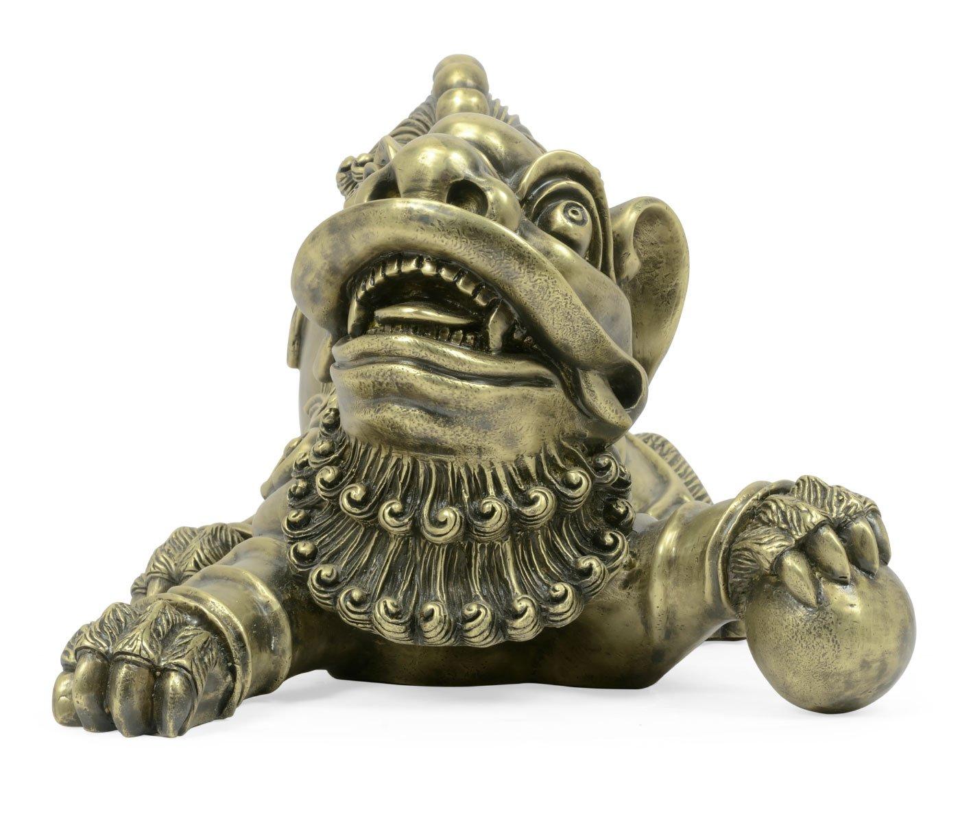 Close-up antique brass Foo Dog face with detailed teeth, tongue, and weathered metallic finish