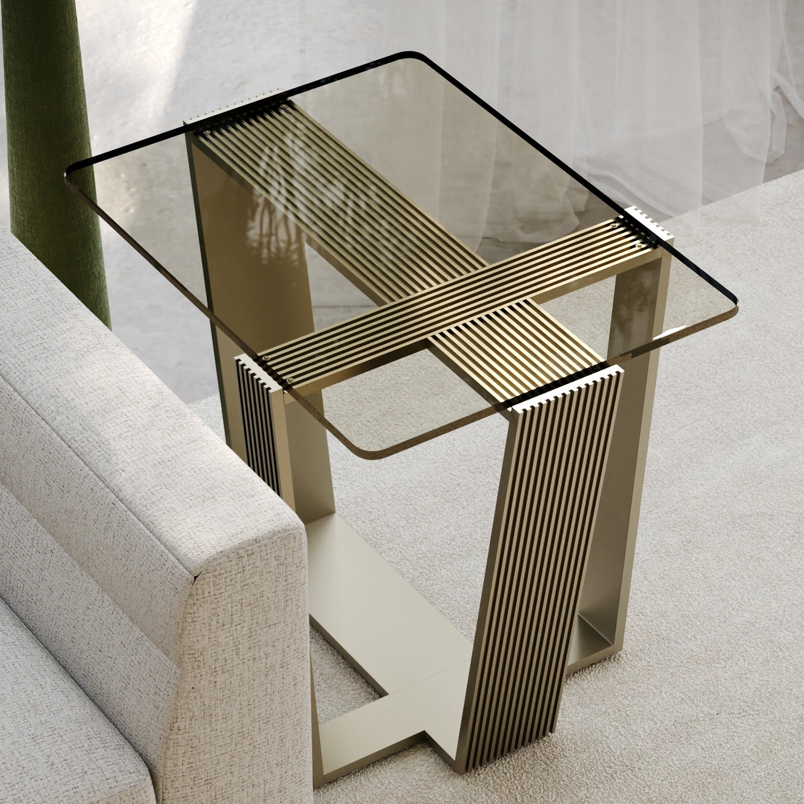Caracole Counter Balance Side Table with smoked bronze glass top and brushed gold ribbed metal frame beside beige sofa