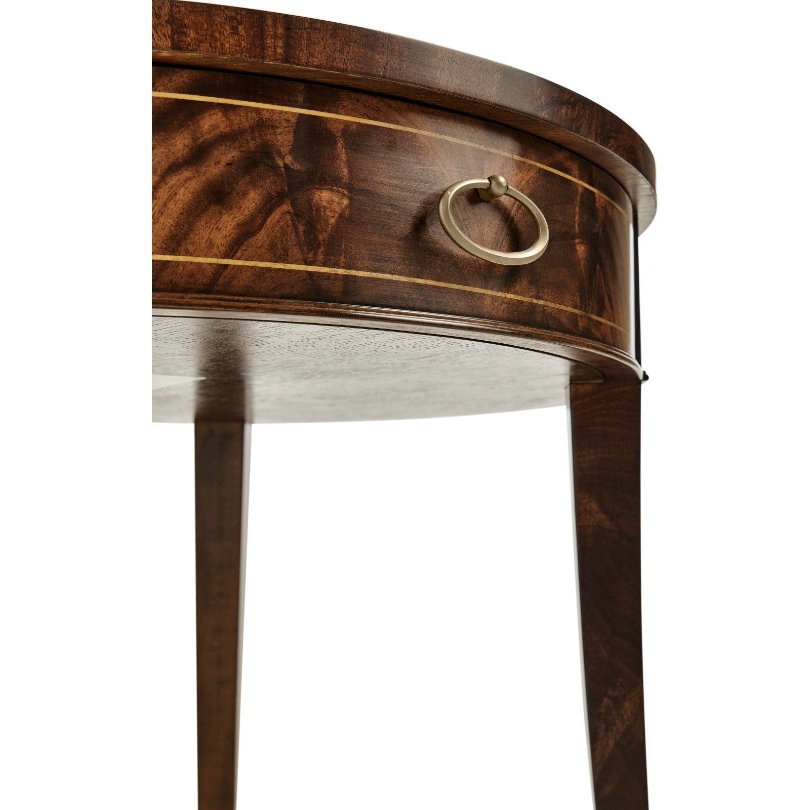 Curved drawer detail of mahogany side table with brass handle and gold inlay