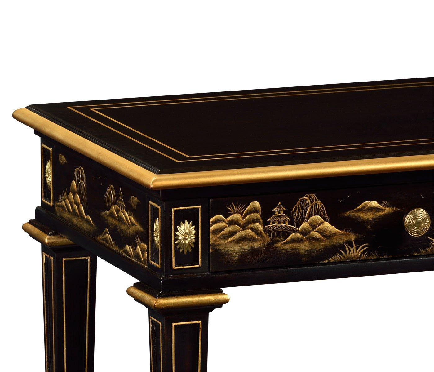 Close-up of hand-painted gold landscape on black lacquer bedside table corner