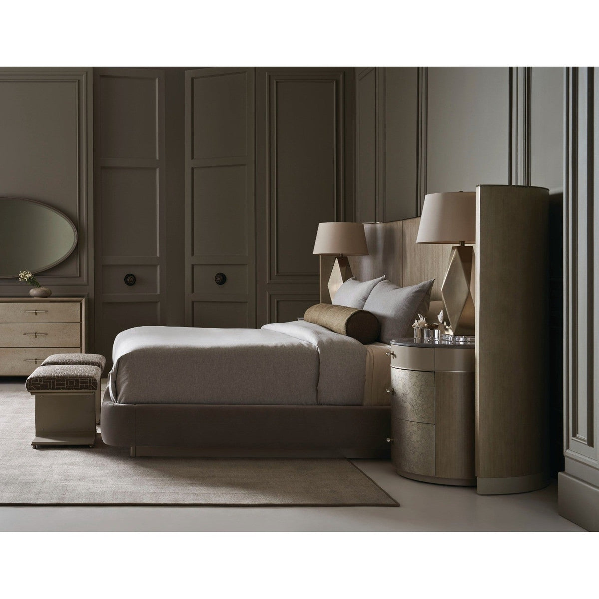 Full bedroom scene with Caracole Hang Up six-drawer dresser featuring oval mirror against paneled taupe walls