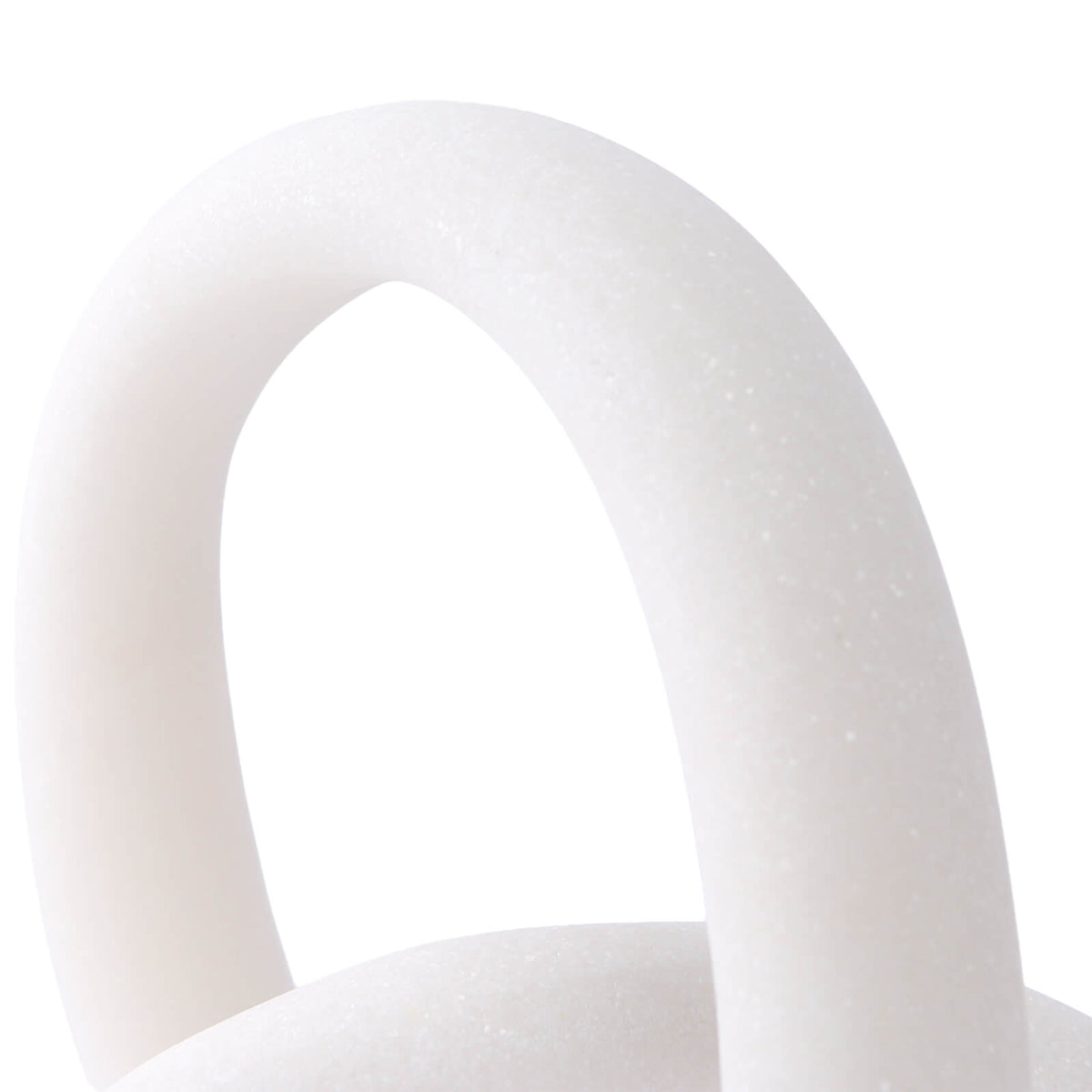 Close-up of white resin loop showing seamless joinery and fine speckled matte finish detail