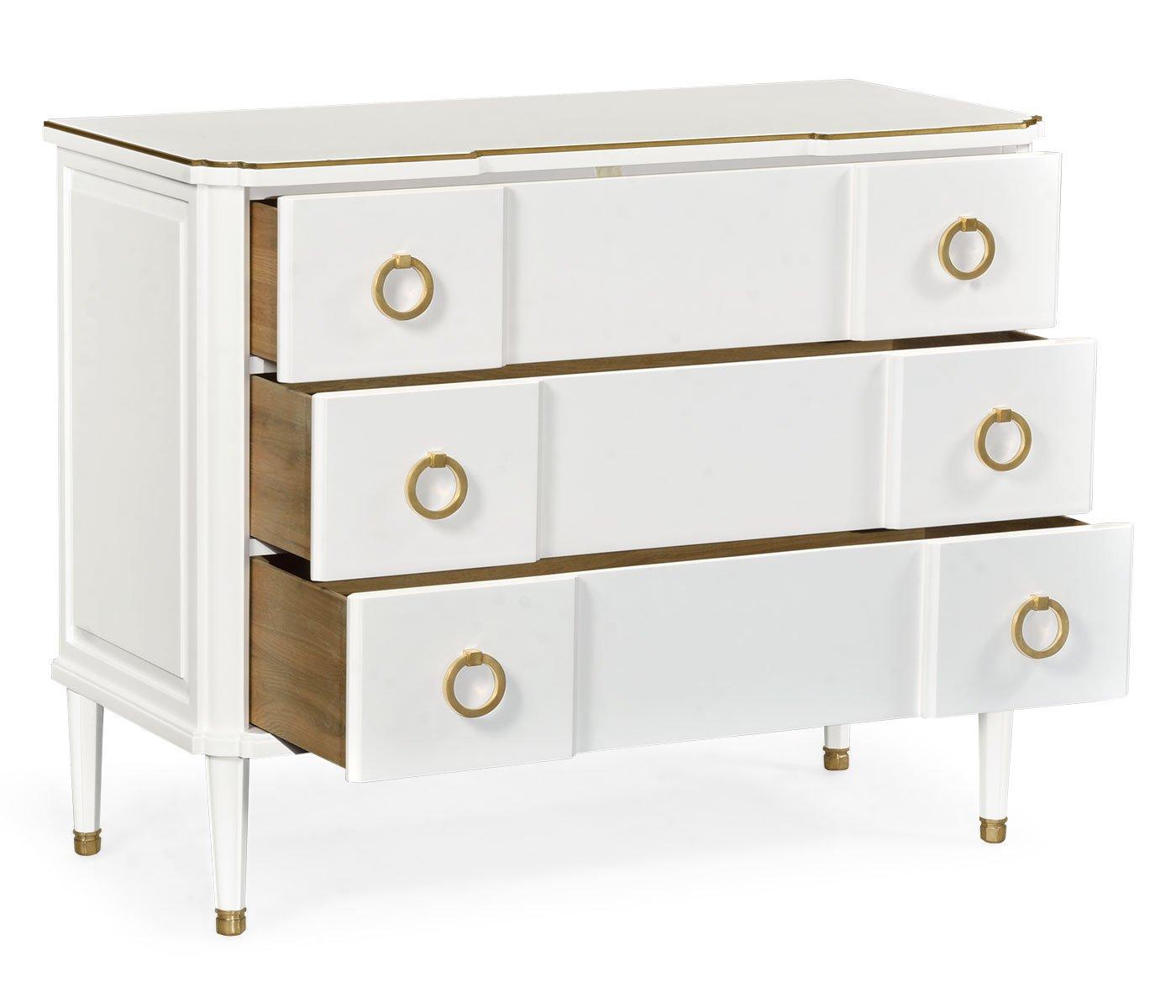 Open ivory chest of drawers showing warm wood interior lining and tapered legs