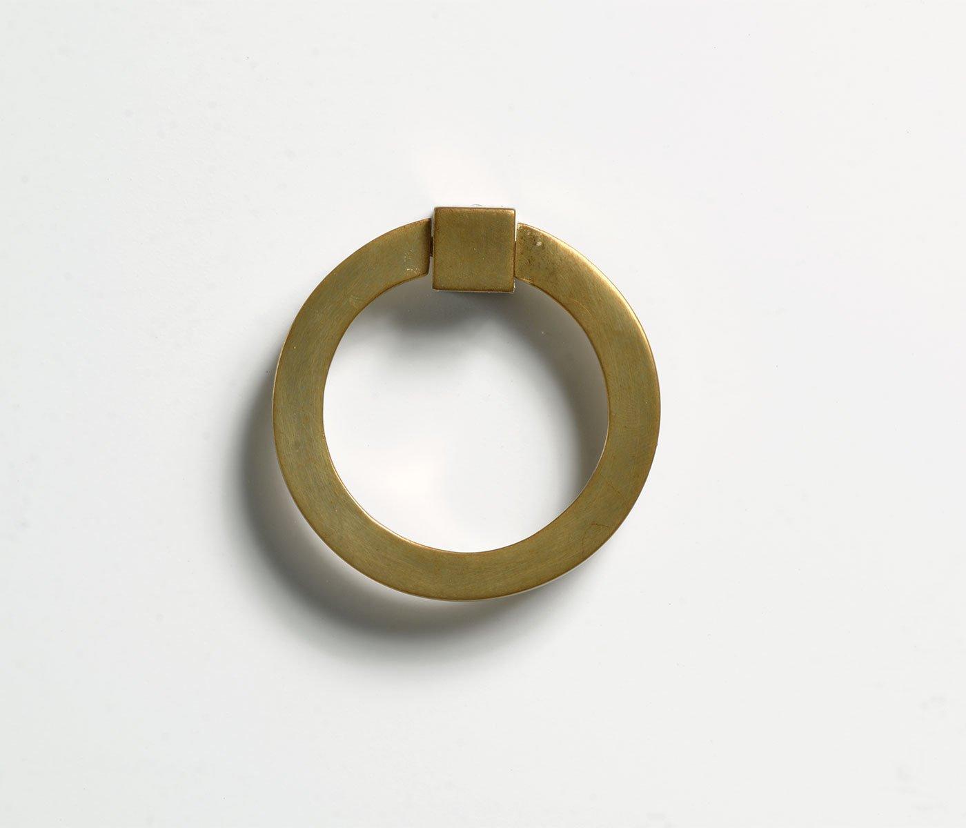 Close-up of brushed gold round brass ring pull hardware with square mounting bracket