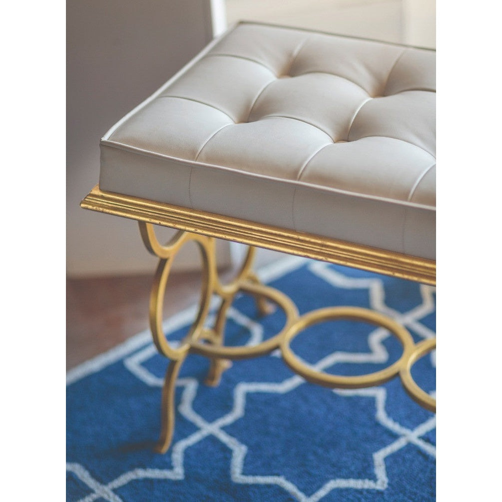 Side view of cream diamond-tufted leather cushion and fluted edge trim on Jonathan Charles Bench Circles