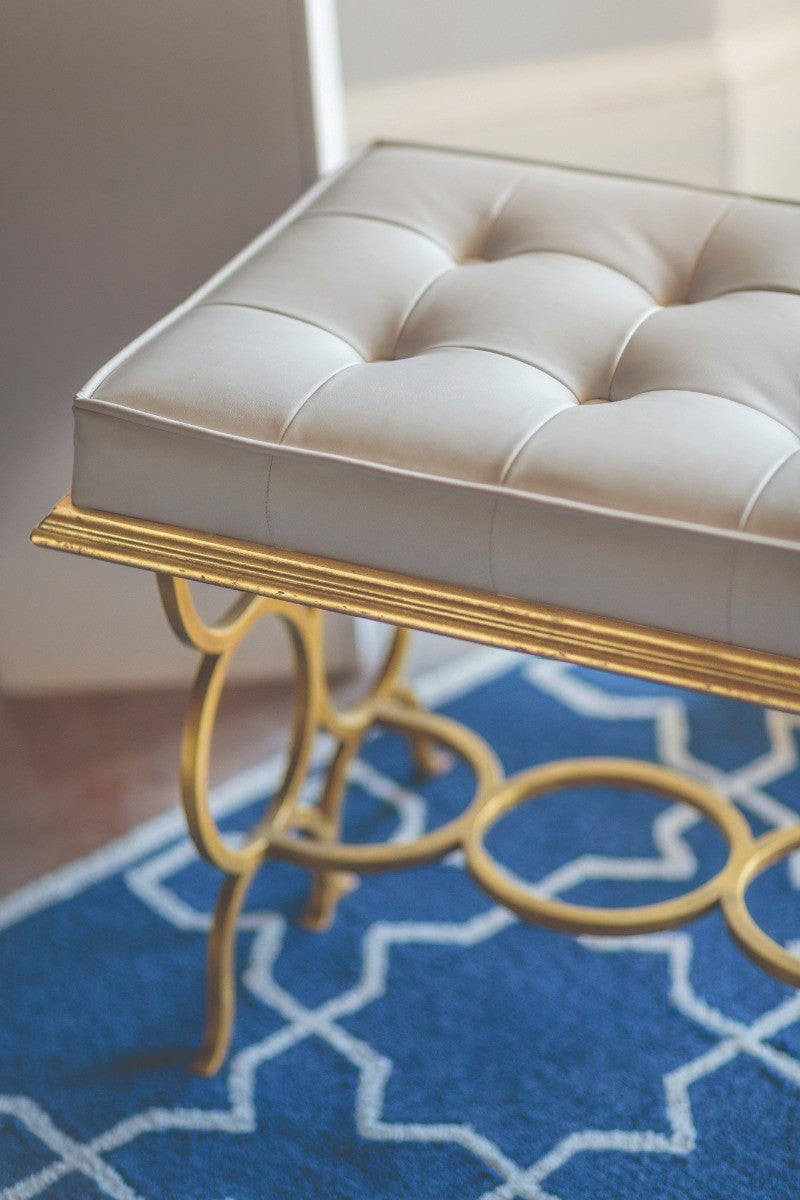 Side view of cream diamond-tufted leather cushion and fluted edge trim on Jonathan Charles Bench Circles