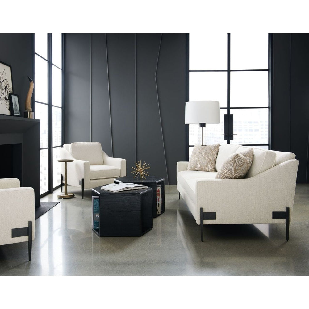 Black hexagon end table with wood grain finish and matte metal legs styled as coffee table with gold sculpture