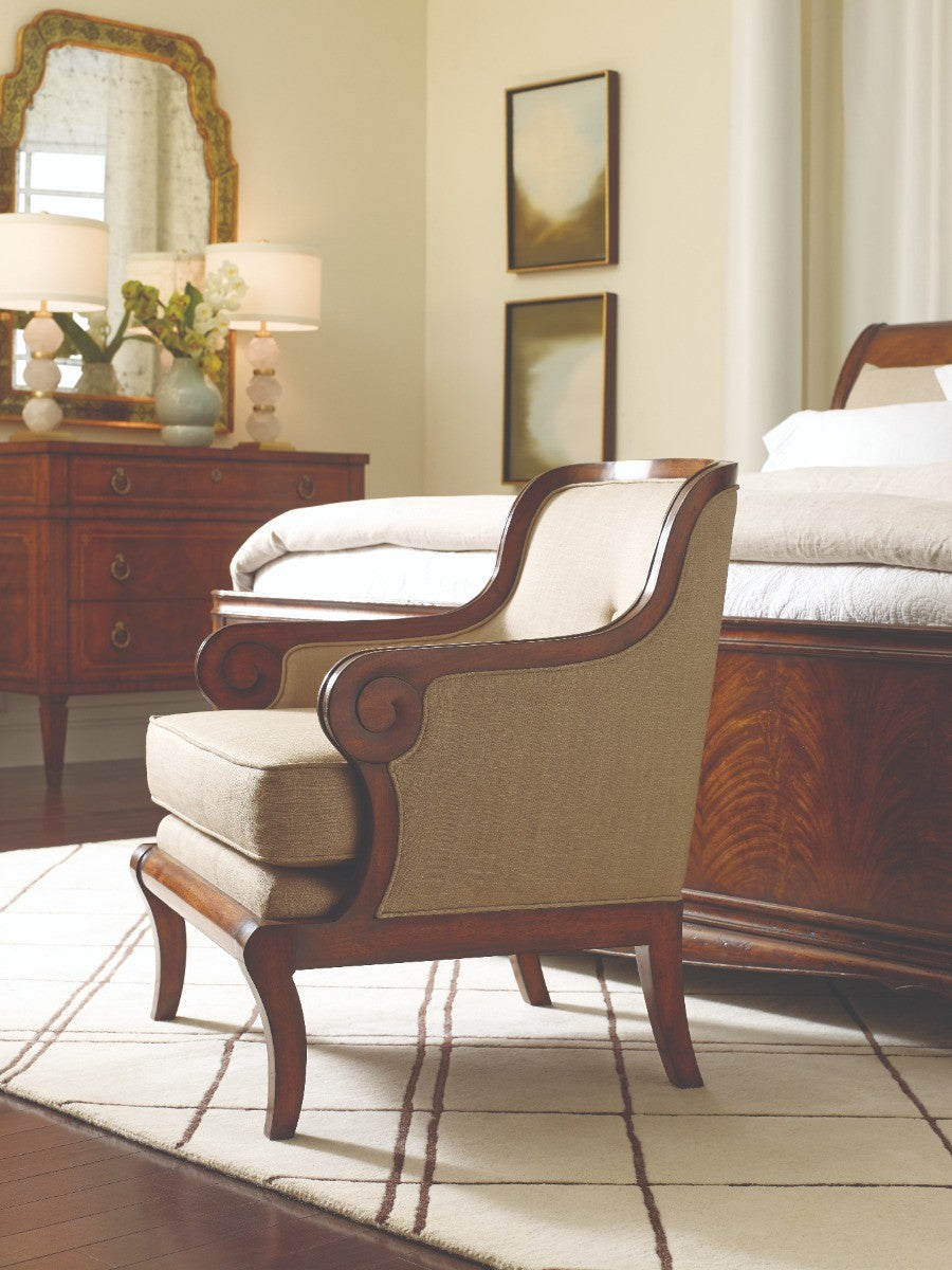 Monarch walnut dresser in bedroom setting with matching armchair and ornate brass hardware